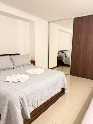 a bedroom with a bed with towels on it at Apartamento Carde Housing in Villa Carlos Paz