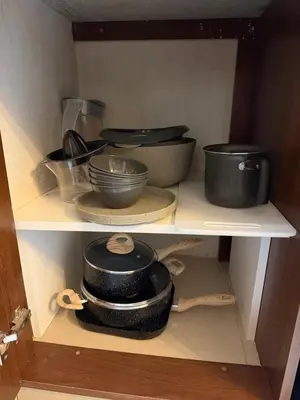 a shelf filled with pots and pans and bowls at Apartamento Carde Housing in Villa Carlos Paz