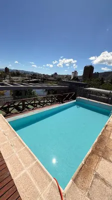 a large blue swimming pool on top of a building at Apartamento Carde Housing in Villa Carlos Paz