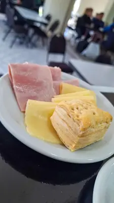 a plate of cheese and meats on a table at KIN Hotel in Villa Carlos Paz