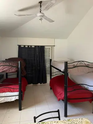 two bunk beds in a room with a ceiling fan at perfecta casa en Cordoba in Cordoba