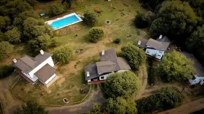 an aerial view of a house with a swimming pool at Cabañas Rey Garcia in Villa General Belgrano