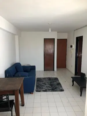 a living room with a blue couch and a table at Departamento 1 dormitorio en la mejor zona del centro de Córdoba in Cordoba