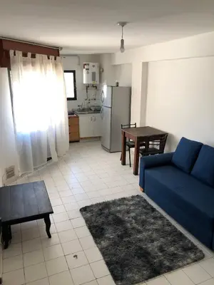 a living room with a blue couch and a table at Departamento 1 dormitorio en la mejor zona del centro de Córdoba in Cordoba