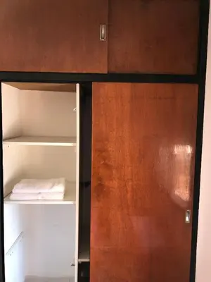 an open cabinet with a wooden door in a room at Departamento 1 dormitorio en la mejor zona del centro de Córdoba in Cordoba
