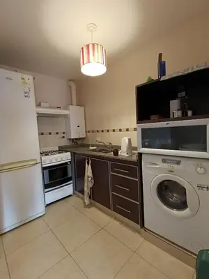 a kitchen with a washing machine and a washer at Departamento Nuevo centro shopping in Cordoba