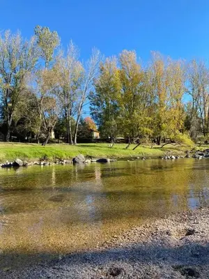 a body of water with trees in the background at CastelAnte1 in Villa Carlos Paz