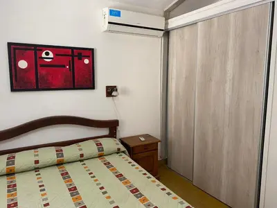 a small bedroom with a bed and a window at CastelAnte1 in Villa Carlos Paz