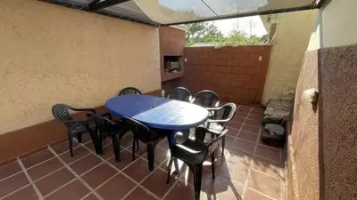a blue table and chairs on a patio at CastelAnte1 in Villa Carlos Paz