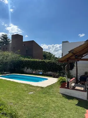 a swimming pool in the yard of a house at Casa Jazmín in Villa Carlos Paz