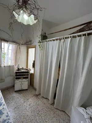 a bedroom with white curtains and a window at Casa Jazmín in Villa Carlos Paz