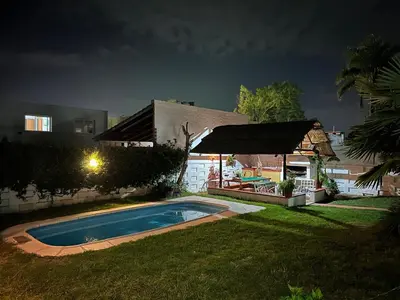 a house with a swimming pool in the yard at night at Casa Jazmín in Villa Carlos Paz