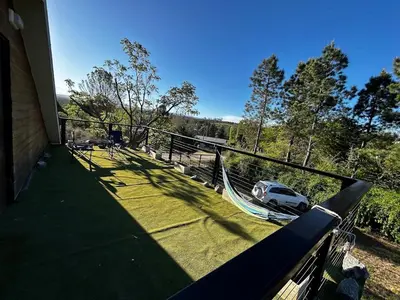a porch with a hammock and a car on it at Terra Nostra in Los Reartes