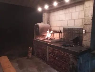 a brick oven with a fire in it at Terra Nostra in Los Reartes