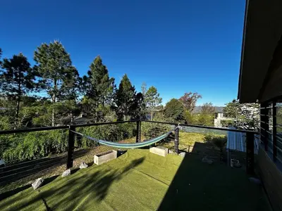 a hammock on a balcony of a house at Terra Nostra in Los Reartes