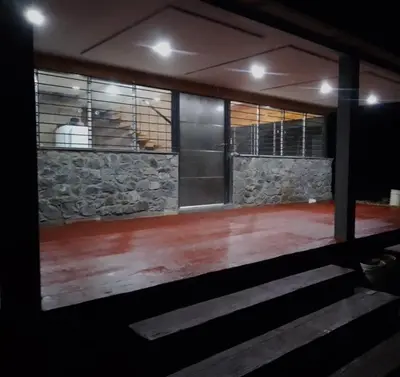 a room with a stone wall and a dance floor at Terra Nostra in Los Reartes