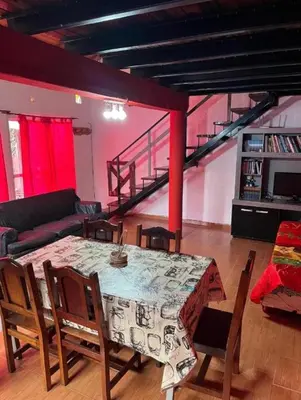 a living room with a table and chairs and a couch at La Morada in Mina Clavero
