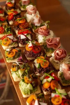 a bunch of appetizers on a wooden board at Hotel Hawai in Villa Carlos Paz