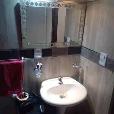 a bathroom with a sink and a mirror at Adorada in Villa Carlos Paz