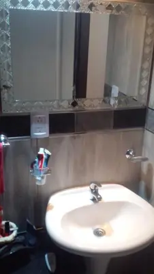 a bathroom with a white sink and a mirror at Adorada in Villa Carlos Paz