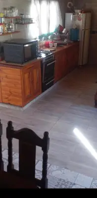 a kitchen with a stove and a refrigerator at Adorada in Villa Carlos Paz