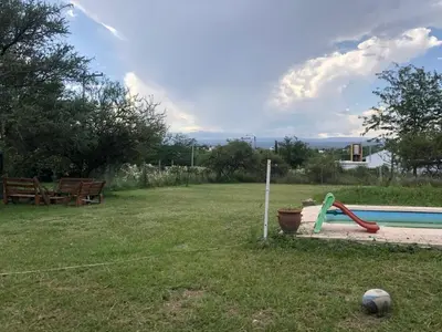 a backyard with a pool with a ball and a playground at Casa Mirador Del Lago in Villa Parque Siquiman