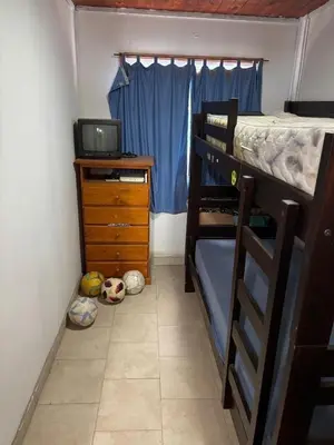 a bedroom with a bunk bed and a desk with a television at Casa Mirador Del Lago in Villa Parque Siquiman
