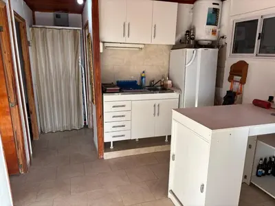 a kitchen with white cabinets and a white refrigerator at Casa Mirador Del Lago in Villa Parque Siquiman