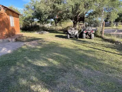 two atvs parked in a yard next to a house at Casa Mirador Del Lago in Villa Parque Siquiman