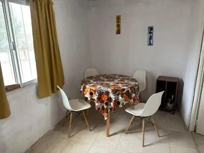 a dining room with a table and four chairs at Casa Mirador Del Lago in Villa Parque Siquiman