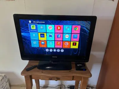 a television sitting on a wooden stand with a remote control at Casa Mirador Del Lago in Villa Parque Siquiman