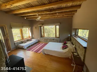 a bedroom with a bed and a couch in it at Cabaña Peperina in San Javier