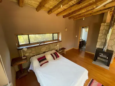 a bedroom with a white bed and a window at Cabaña Peperina in San Javier