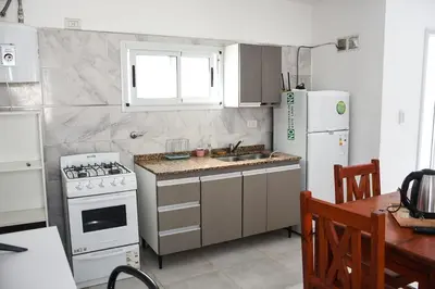 a kitchen with a stove and a white refrigerator at Rio Segundo Colo 2 in Río Segundo