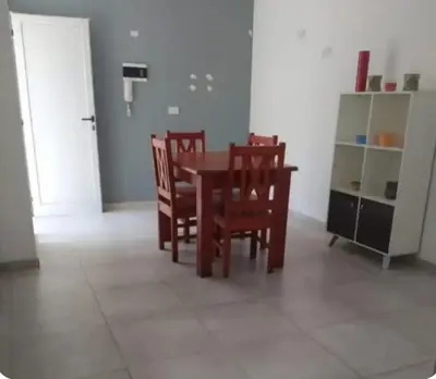 a dining room with a table and chairs and a cabinet at Rio Segundo Colo 2 in Río Segundo