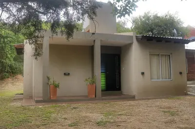 a small house with two plants in front of it at Quiya ná in Cortaderas
