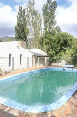 a swimming pool in the backyard of a house at Quiya ná in Cortaderas