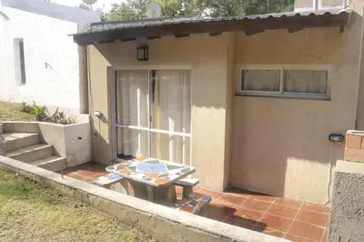 a patio with a table in front of a house at Quiya ná in Cortaderas