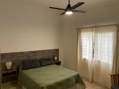 a bedroom with a bed and a ceiling fan at Casa del Roble in Alta Gracia