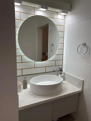 a bathroom with a large white sink and a mirror at Casa del Roble in Alta Gracia