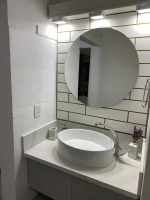 a white bathroom with a sink and a mirror at Casa del Roble in Alta Gracia
