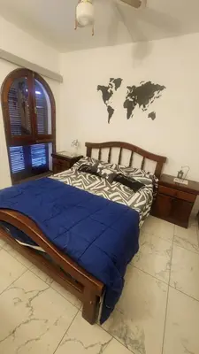a bedroom with a bed with a map on the wall at Apartamento con bajada al lago Aldea del Puente in Villa Carlos Paz