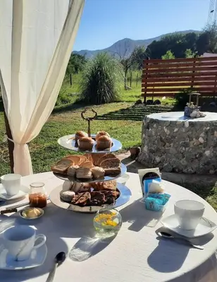 a table with plates of food on top of it at CabañaPaz in Santa Rosa de Calamuchita