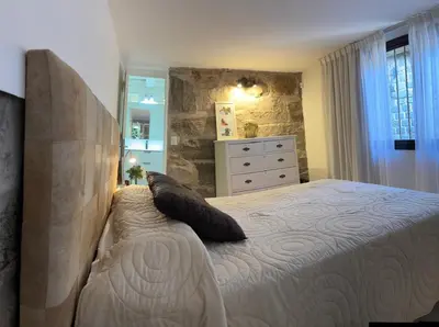 a bedroom with a large bed and a dresser at Casa Campo La Carolina in Cordoba