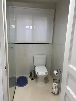 a bathroom with a white toilet in a room at Casa Campo La Carolina in Cordoba