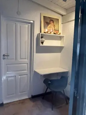 a bathroom with a white sink and a blue chair at Casa Campo La Carolina in Cordoba