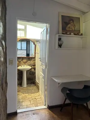 a room with a door open to a bathroom with a sink at Casa Campo La Carolina in Cordoba