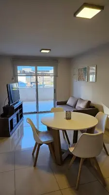 a living room with a table and a couch at Departamento en Opera fun 2nd piso in Villa Carlos Paz