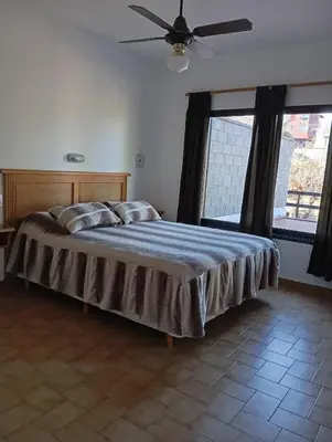 a bedroom with a bed and a ceiling fan at Casa Lago Azul in Villa Santa Cruz del Lago