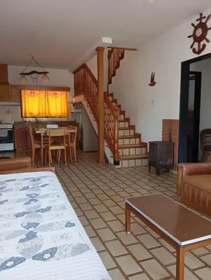 a living room with a staircase and a living room at Casa Lago Azul in Villa Santa Cruz del Lago